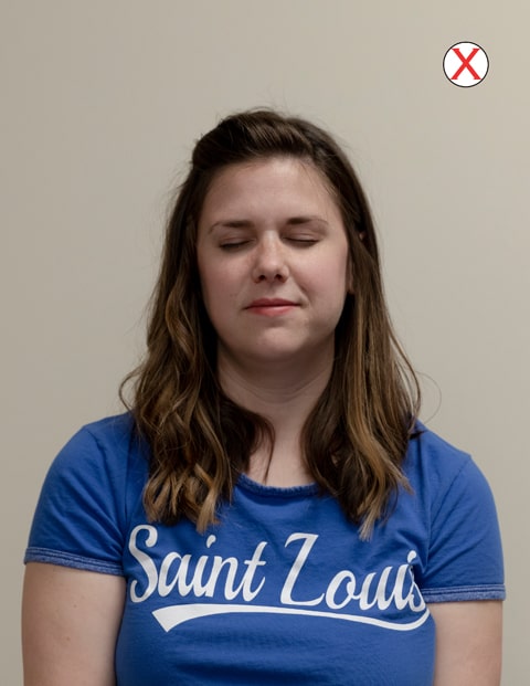 Example of bad eyes A headshot of a woman wearing a SLU t-shirt. Her eyes are closed.