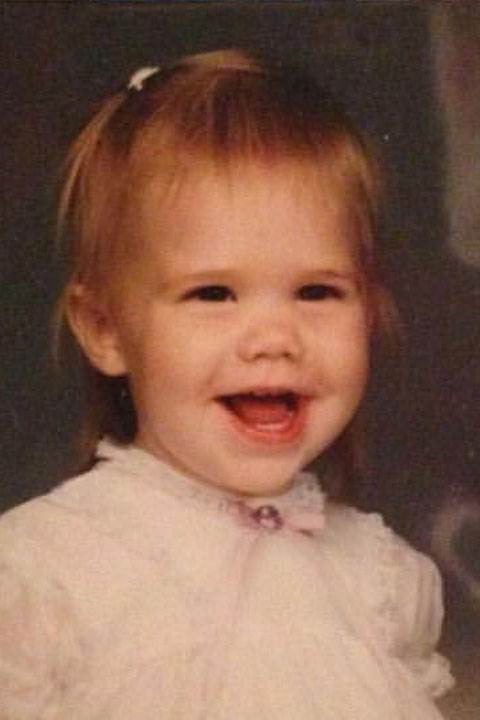 Example of wrong age photo A headshot of a young toddler smiling at the camera.
