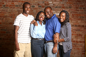 Tiffany Anderson poses for a photo with her late husband and two children.