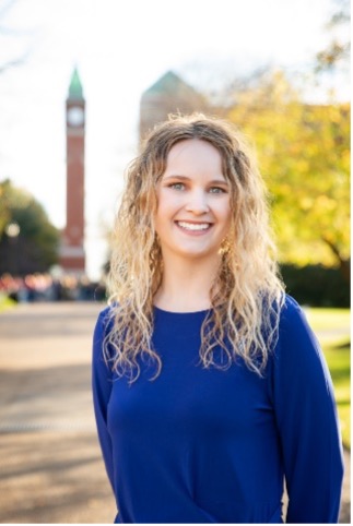 Danielle McTigue stands in front of the SLU clock tower