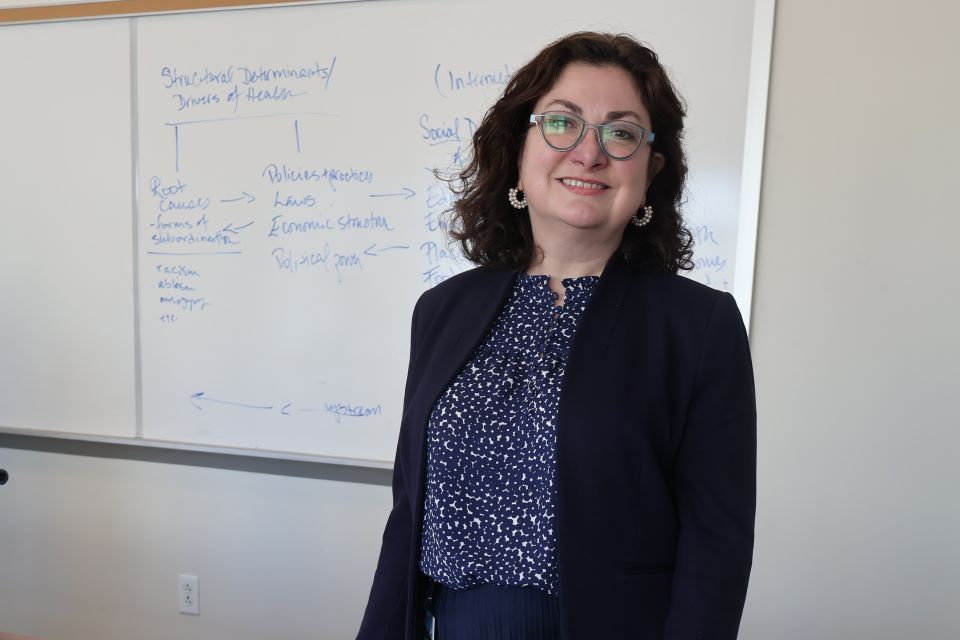 Professor Danielle Pelfrey Duryea poses in front front of the white board in a classroom Daniell Pelfrey Duryea poses in the classroom in front of a white board.