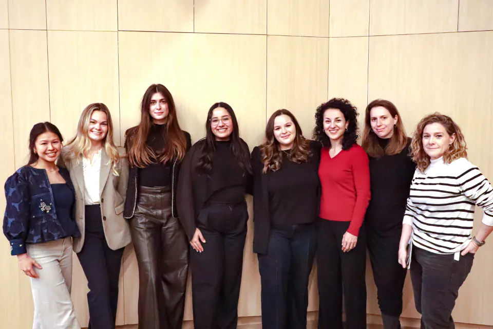 A group of women, including guest speakers and members of the Women in Business Club, stand together and pose for a photo.