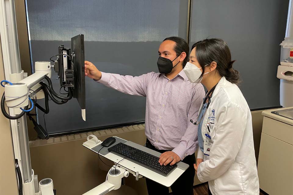 resident and doctor infront of computer