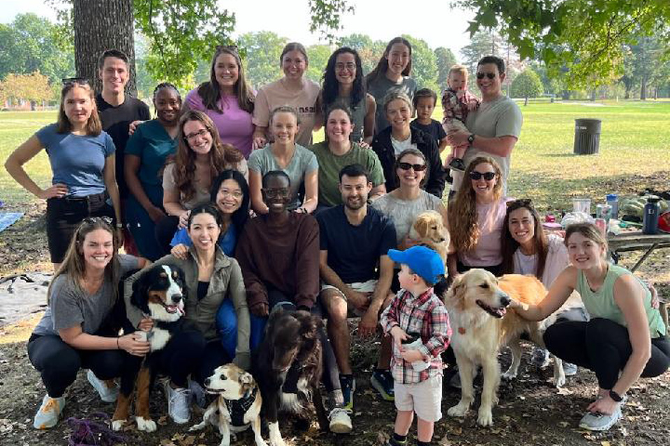 A group of about 20 residents pose for a photo outdoors.