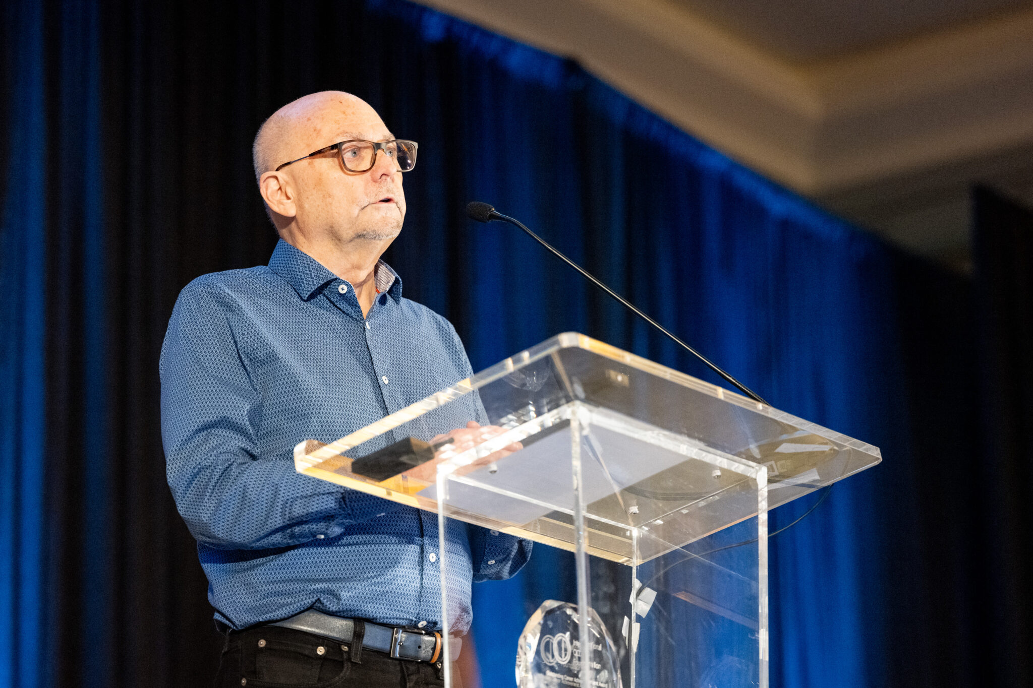 Alec Pollard, Ph.D., professor emeritus of family and community medicine at Saint Louis University School of Medicine, addresses an audience after receiving the International OCD Foundation (IOCDF)’s 2024 Outstanding Career Achievement Award.