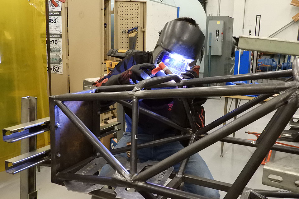 Junior Jacob Bullard welds on the Parks Racing Club's chassis.