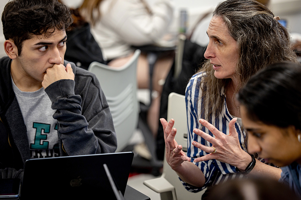 A professor speaks with a student