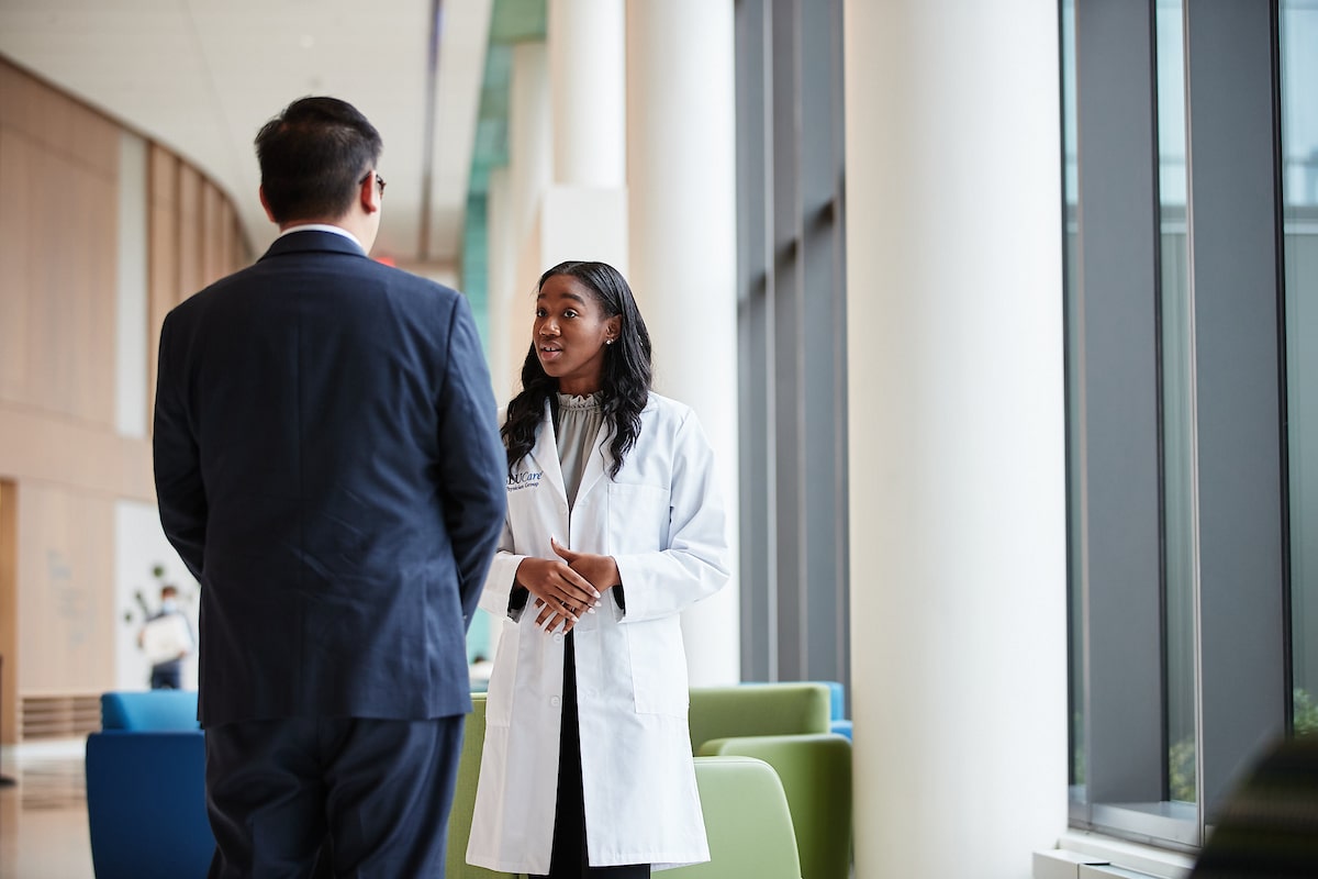 Doctor meeting with individual near windows