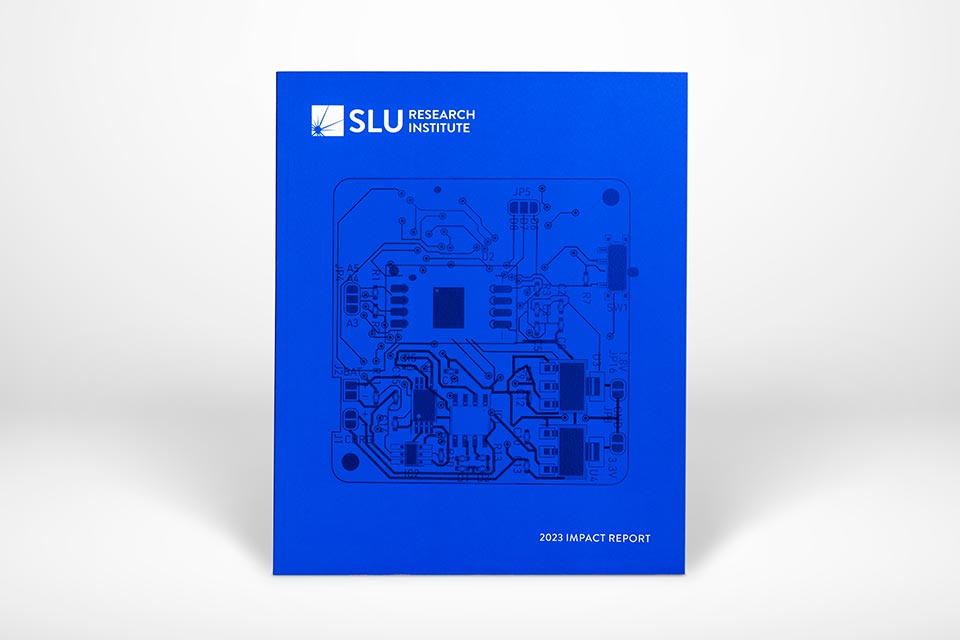 A copy of the 2023 Impact Report and its cover slip standing against a white background