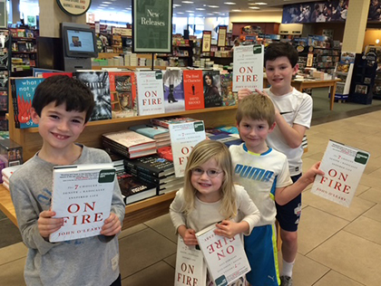 O'Leary children with copies of On Fire book in a bookstore